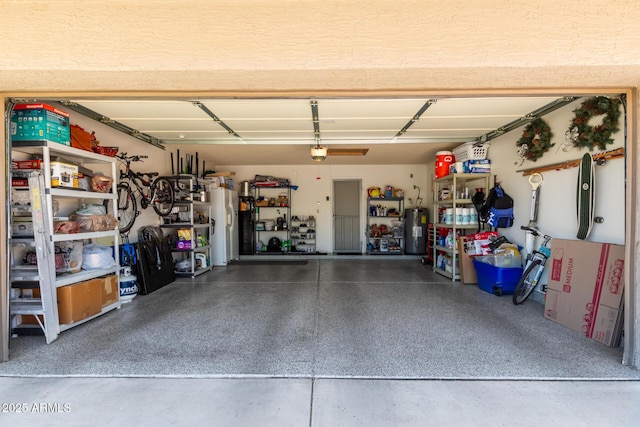6017 E Kathleen Rd, Scottsdale, AZ 85254 - garage featuring electric water heater and a garage door opener