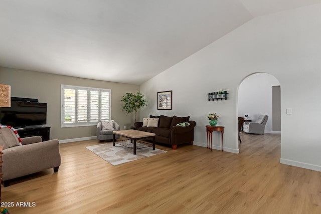 6017 E Kathleen Rd, Scottsdale, AZ 85254 - living area with arched walkways, light wood-style flooring, and high vaulted ceiling
