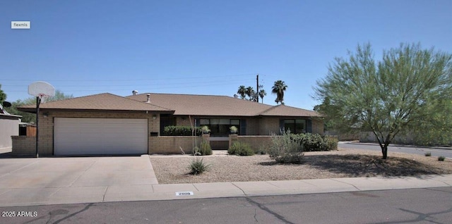 ranch-style house featuring driveway, a garage, and brick siding