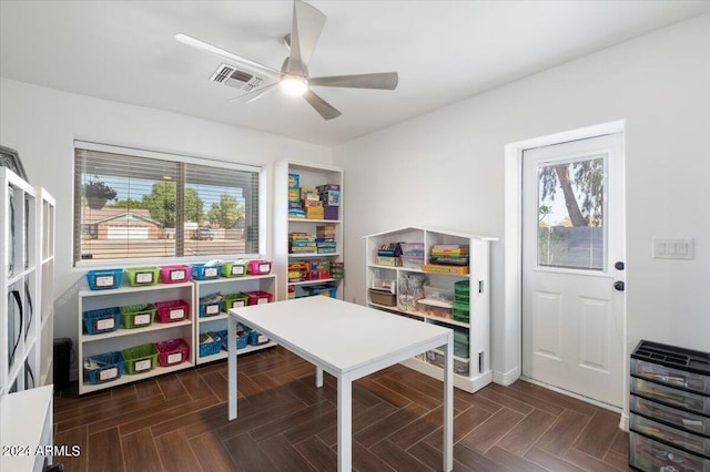 playroom featuring ceiling fan and dark parquet flooring