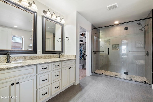 bathroom with vanity and an enclosed shower