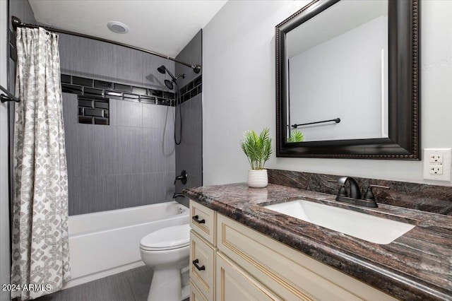 full bathroom with vanity, shower / bath combo with shower curtain, and toilet