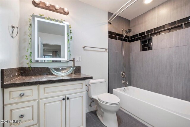 full bathroom featuring vanity, tile patterned flooring, toilet, and tiled shower / bath combo