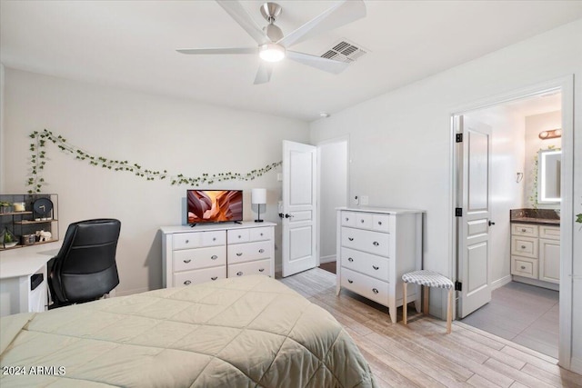 bedroom with ceiling fan, light hardwood / wood-style flooring, and connected bathroom