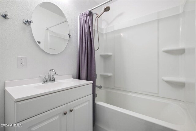 bathroom featuring vanity and shower / bathtub combination with curtain