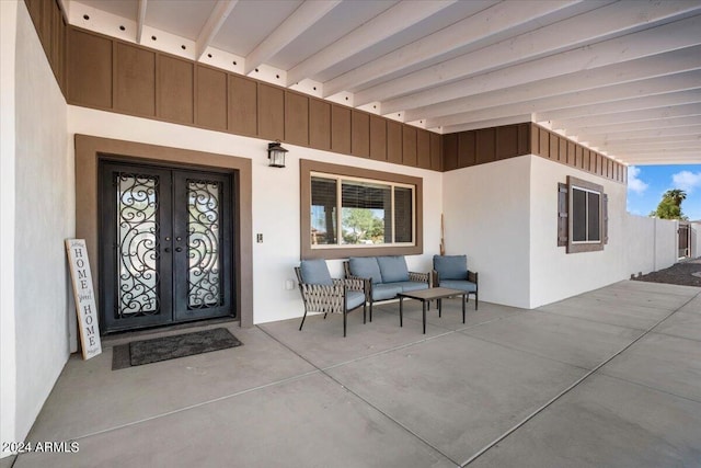 view of exterior entry featuring french doors and a patio