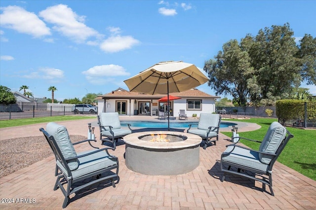 view of patio / terrace featuring a fire pit and a fenced in pool