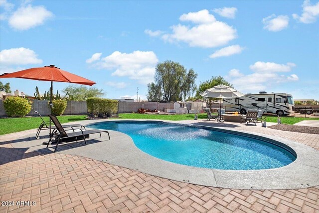 view of pool featuring a yard and a patio