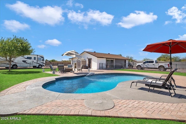 view of swimming pool with a yard and a patio