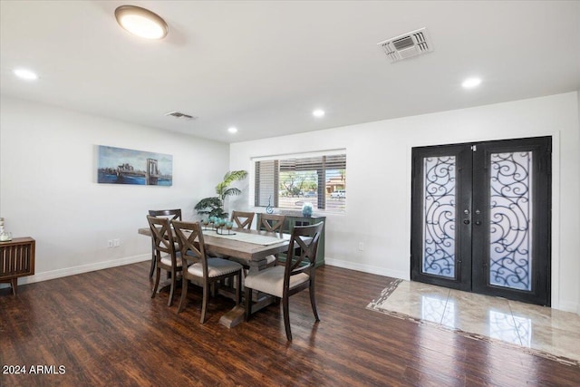 dining area with dark wood-type flooring and french doors