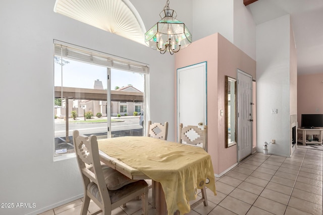 1111 W Summit Pl Unit 85, Chandler, AZ 85224 - dining space featuring baseboards, an inviting chandelier, a towering ceiling, and light tile patterned floors