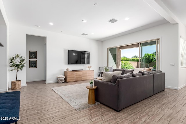 4077 S Quinn Ave, Gilbert, AZ 85297 - living room featuring baseboards, visible vents, and light wood-style floors