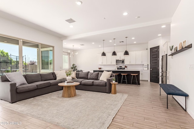 4077 S Quinn Ave, Gilbert, AZ 85297 - living room featuring recessed lighting, visible vents, a chandelier, and light wood-style floors