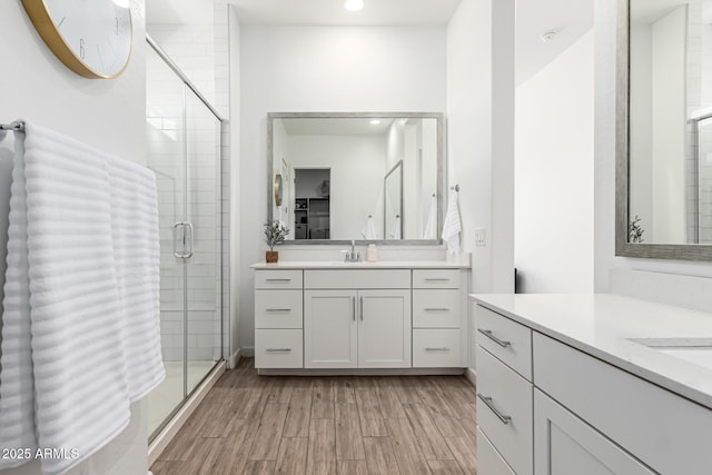 4077 S Quinn Ave, Gilbert, AZ 85297 - full bathroom featuring a sink, recessed lighting, a shower stall, wood finished floors, and two vanities
