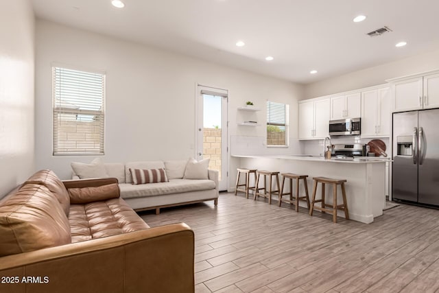 4077 S Quinn Ave, Gilbert, AZ 85297 - living room featuring recessed lighting, visible vents, and light wood finished floors