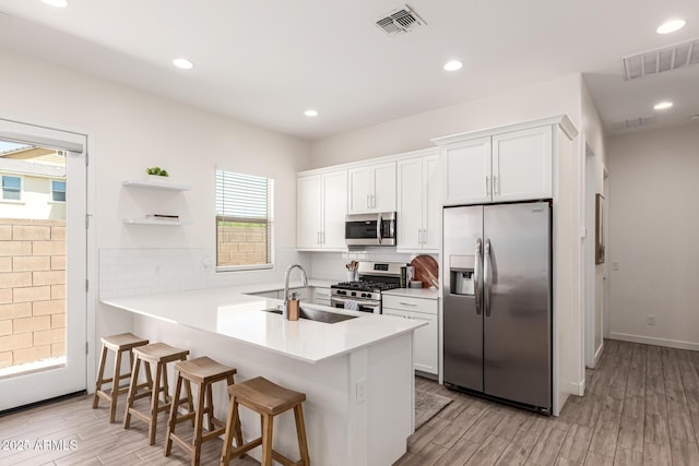 4077 S Quinn Ave, Gilbert, AZ 85297 - kitchen with a sink, white cabinets, stainless steel appliances, and visible vents