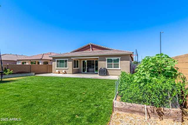4077 S Quinn Ave, Gilbert, AZ 85297 - rear view of property with a patio, a fenced backyard, stucco siding, and a yard
