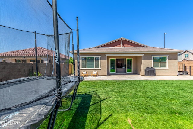 4077 S Quinn Ave, Gilbert, AZ 85297 - back of property with fence, stucco siding, a lawn, and a patio area