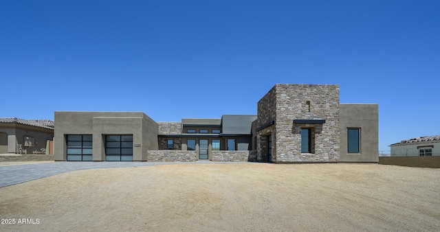 13290 E Ln Junta Rd, Scottsdale, AZ 85255 - contemporary home featuring stone siding and a garage