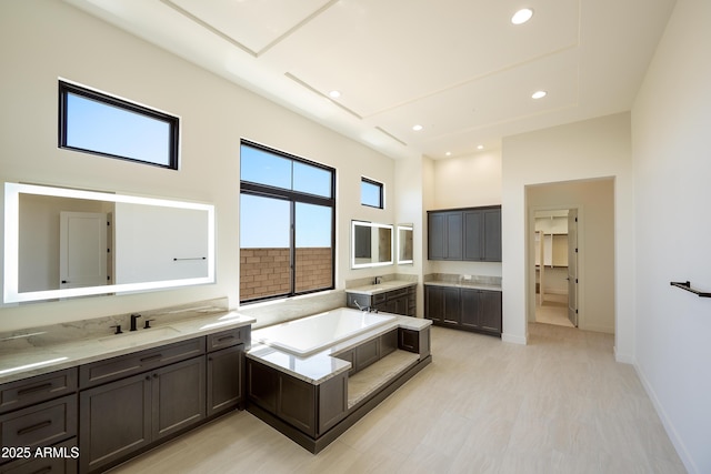 13290 E Ln Junta Rd, Scottsdale, AZ 85255 - full bath with two vanities, a garden tub, recessed lighting, a high ceiling, and baseboards