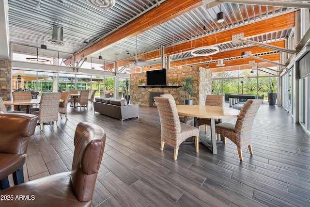 dining space featuring healthy amount of natural light, wood finished floors, and beam ceiling