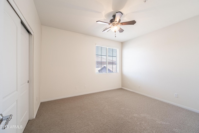 unfurnished bedroom with a closet, carpet floors, baseboards, and ceiling fan