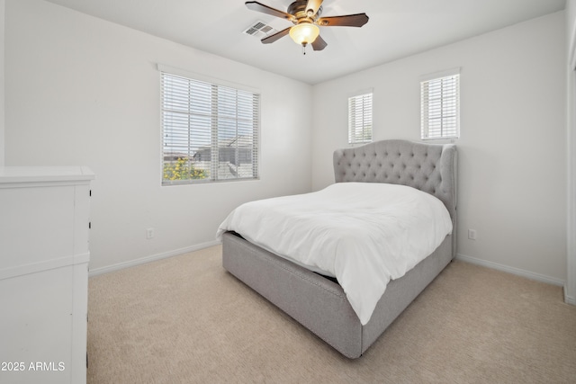 bedroom featuring light carpet, baseboards, and a ceiling fan