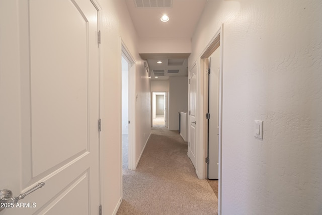 hallway featuring light carpet, recessed lighting, and baseboards