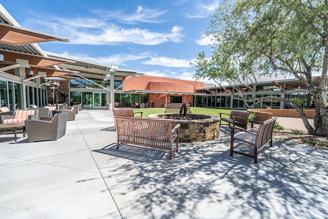 view of patio / terrace with an outdoor living space with a fire pit