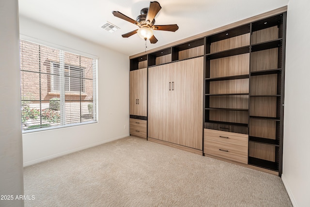 unfurnished bedroom featuring light colored carpet and baseboards