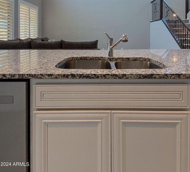 kitchen with dark stone countertops and sink