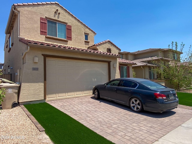 mediterranean / spanish house featuring a garage