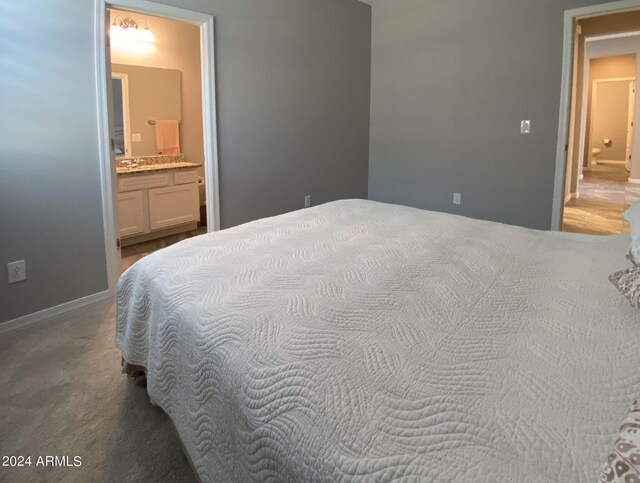 bedroom featuring carpet flooring and connected bathroom