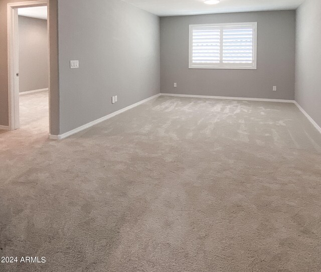 empty room featuring light carpet