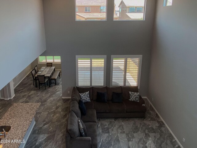 living room featuring a wealth of natural light and a high ceiling