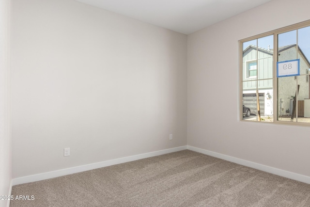 empty room with carpet flooring and baseboards