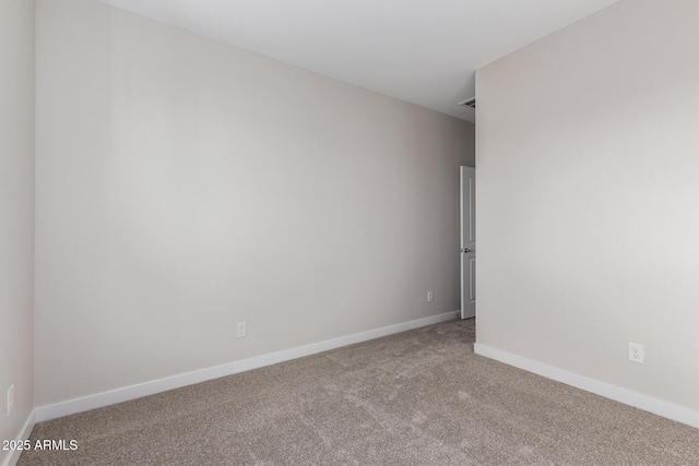 carpeted spare room with baseboards