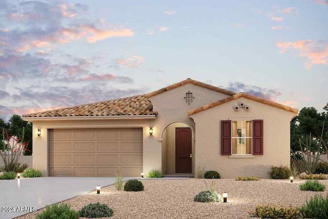 mediterranean / spanish-style home featuring a garage