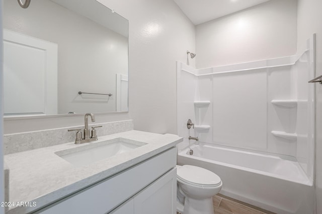 full bathroom with vanity, wood-type flooring,  shower combination, and toilet