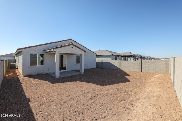 rear view of house featuring a patio and central AC unit