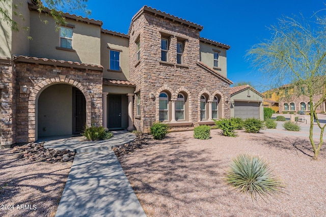 mediterranean / spanish-style house with a garage