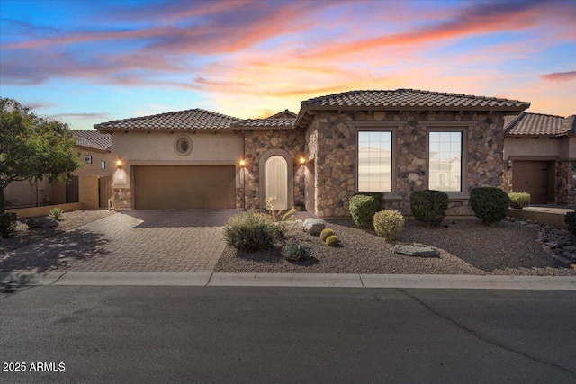 mediterranean / spanish-style house with a garage