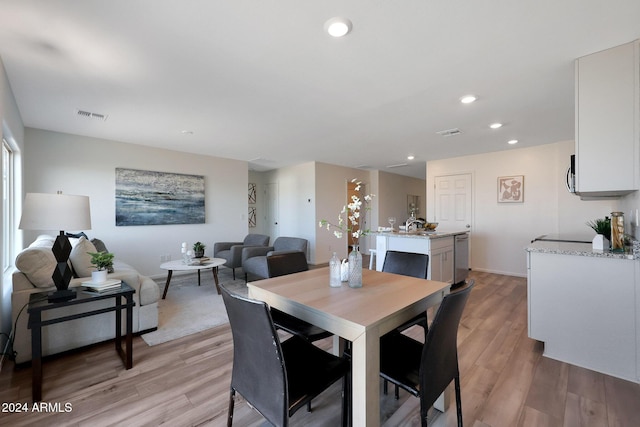 dining area featuring light wood-type flooring