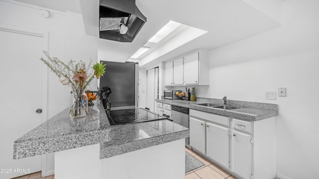 10420 N 10th St Unit 2, Phoenix, AZ 85020 - kitchen featuring tile counters, extractor fan, a sink, white cabinets, and stainless steel appliances