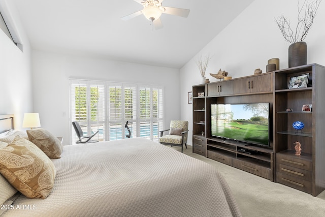 bedroom featuring access to outside, vaulted ceiling, a ceiling fan, and carpet floors