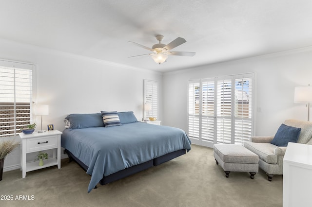 bedroom featuring a ceiling fan, carpet floors, and ornamental molding