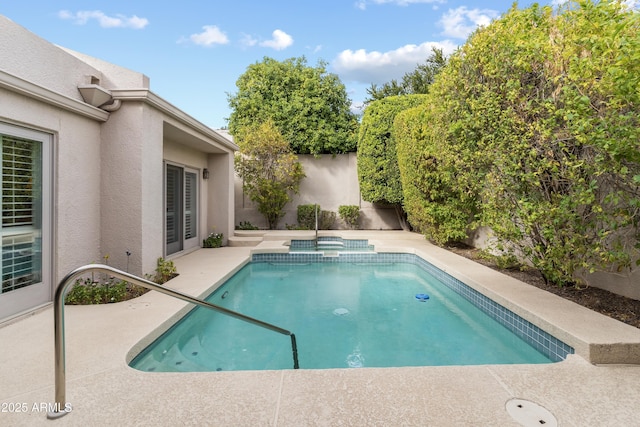 view of swimming pool with a patio, a fenced backyard, and a pool with connected hot tub