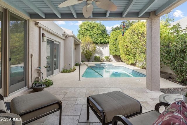 view of pool with a patio area, a fenced backyard, a pool with connected hot tub, and ceiling fan