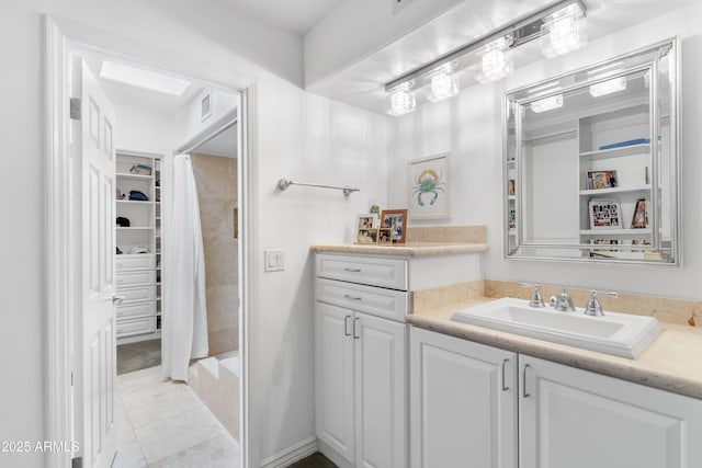 full bath featuring vanity, visible vents, tile patterned flooring, a shower stall, and a spacious closet