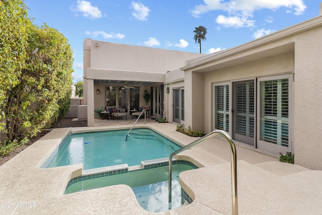 view of pool featuring a pool with connected hot tub and a patio area